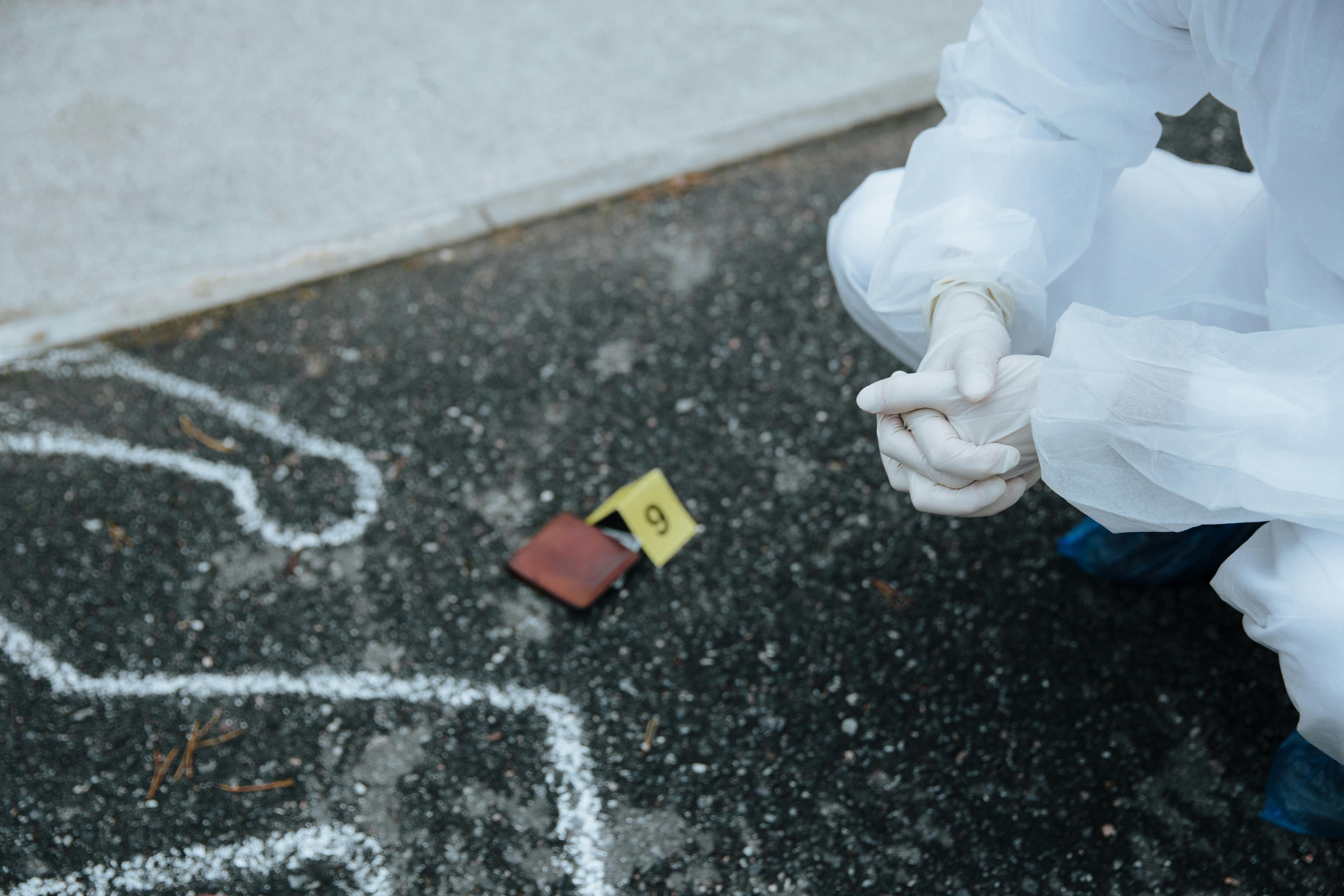 A forensic investigator examining a crime scene