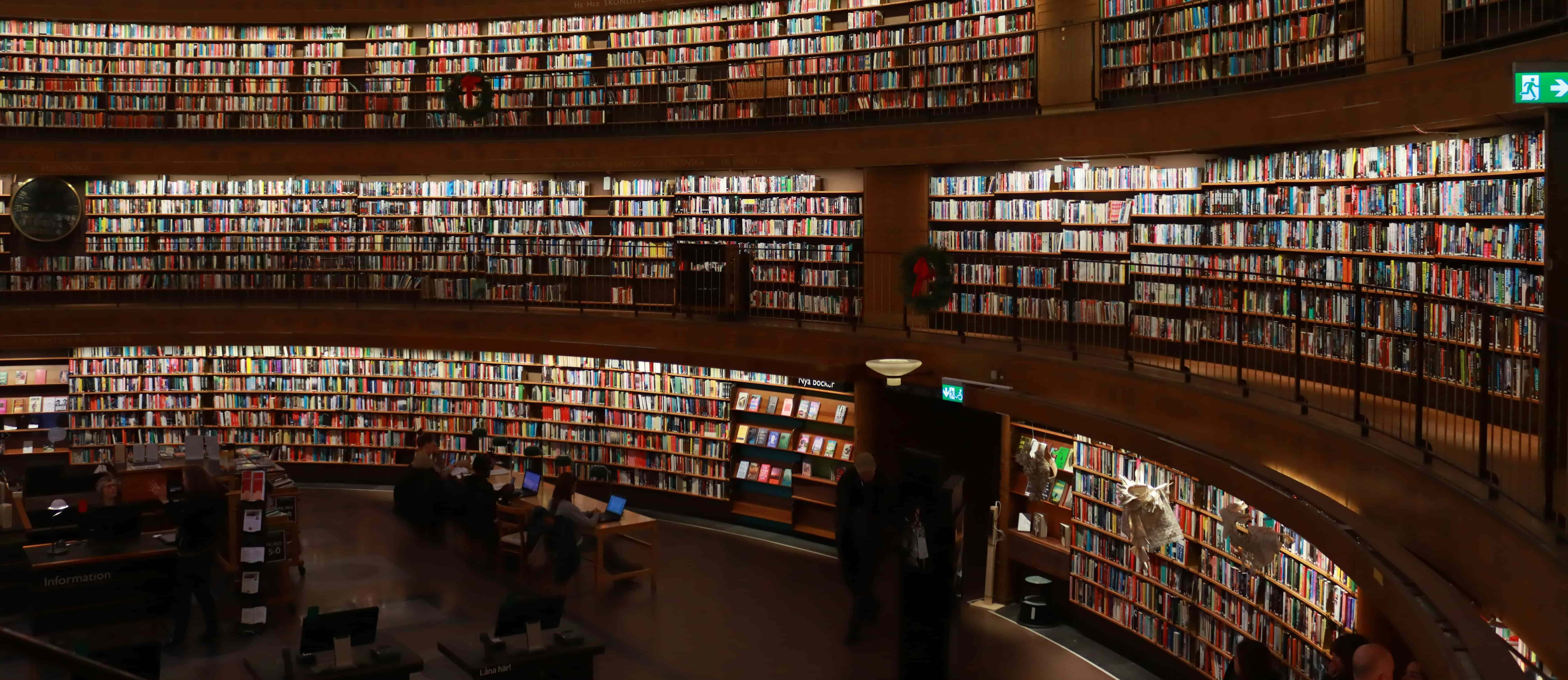 A circular library with bookshelves reaching the ceiling.