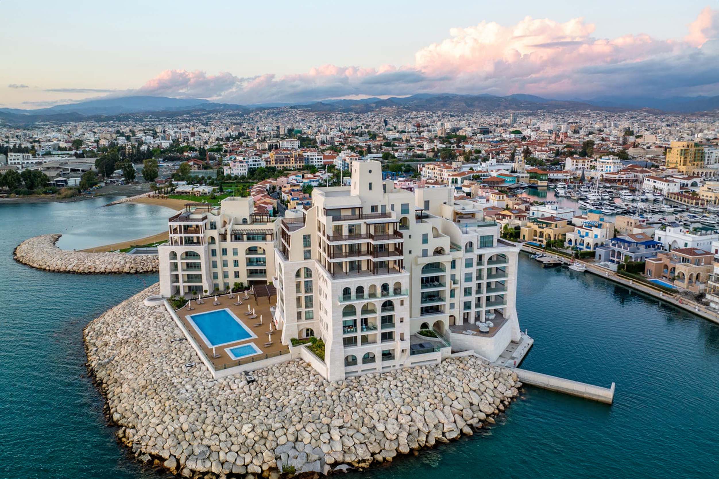 Limassol Marina, Cyprus: Aerial view of a luxurious apartment complex located on a peninsula overlooking the Mediterranean Sea.