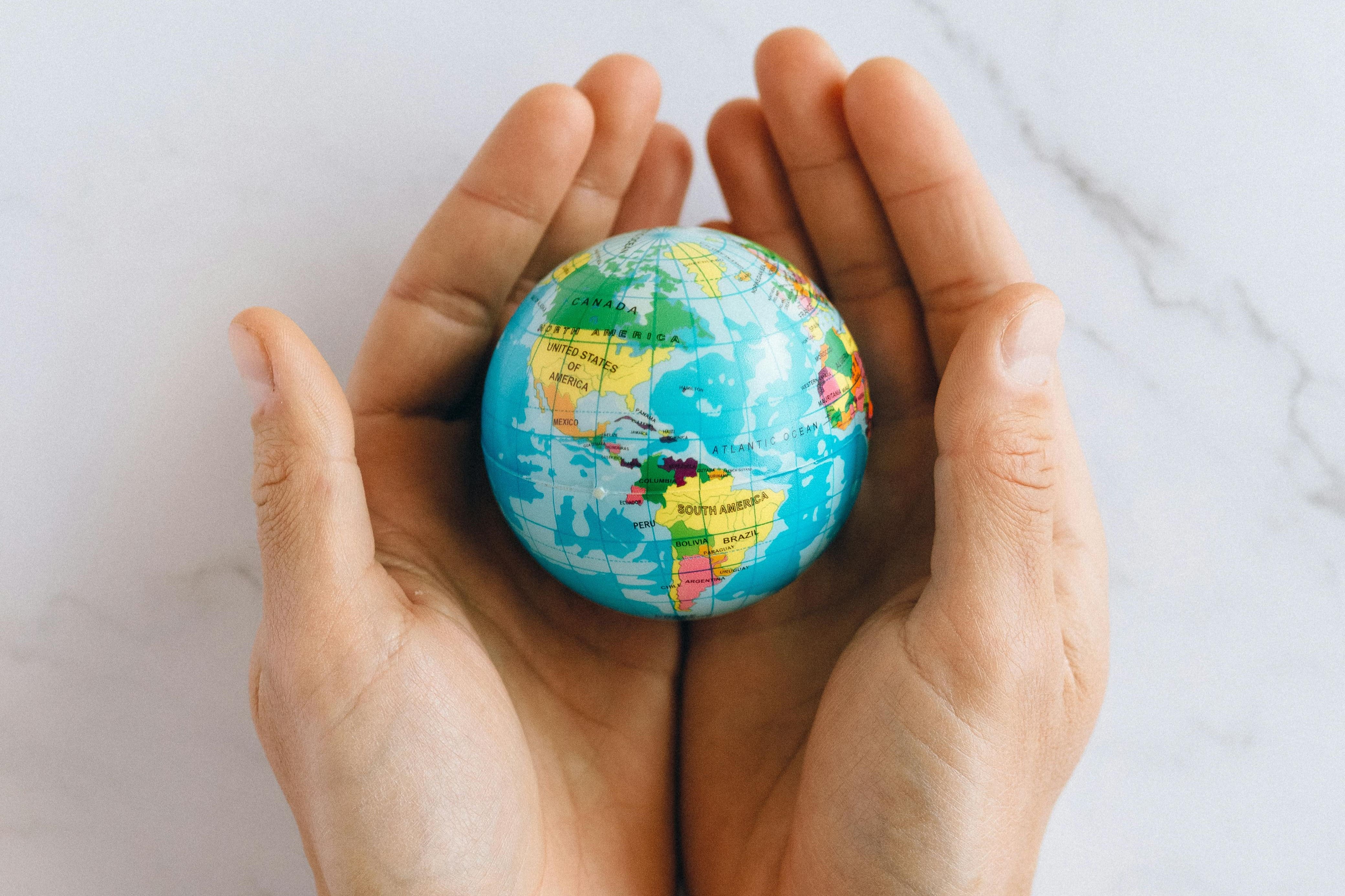 Hands holding globe