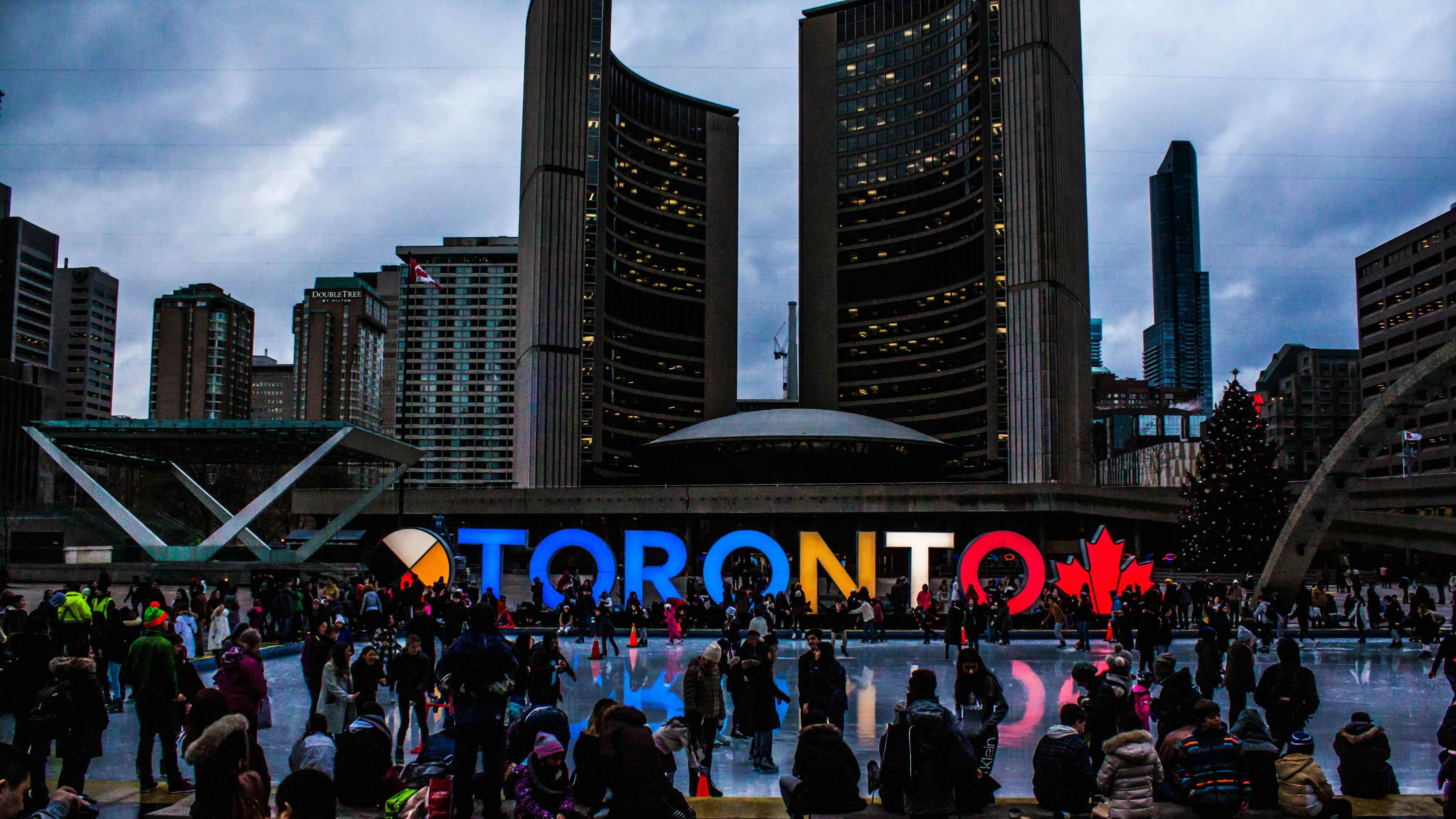 People Gathered in Front of Toronto(Canada) Freestanding Signage