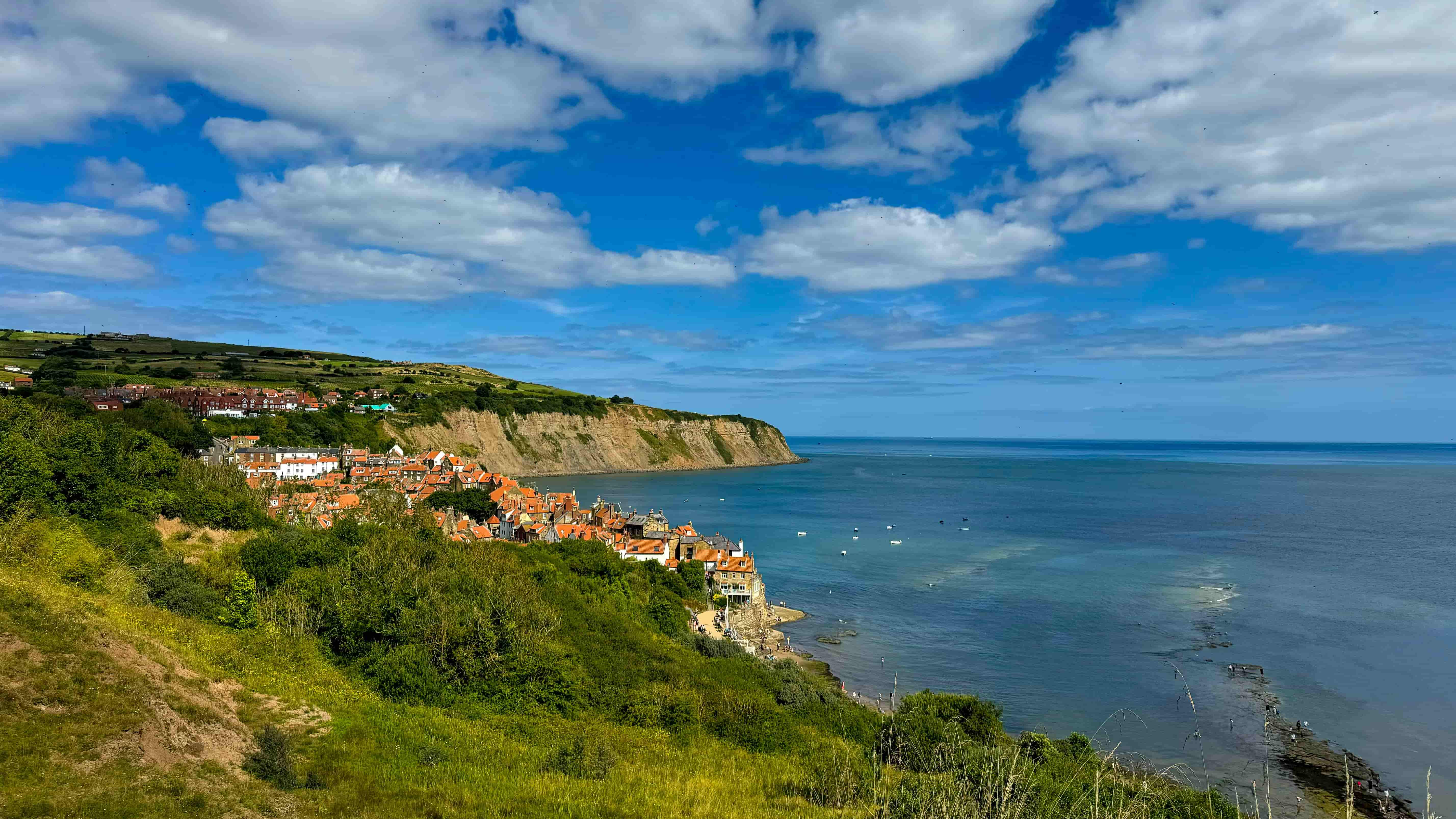 Scenic View of Whitby Coastline with Cliffs and Sea