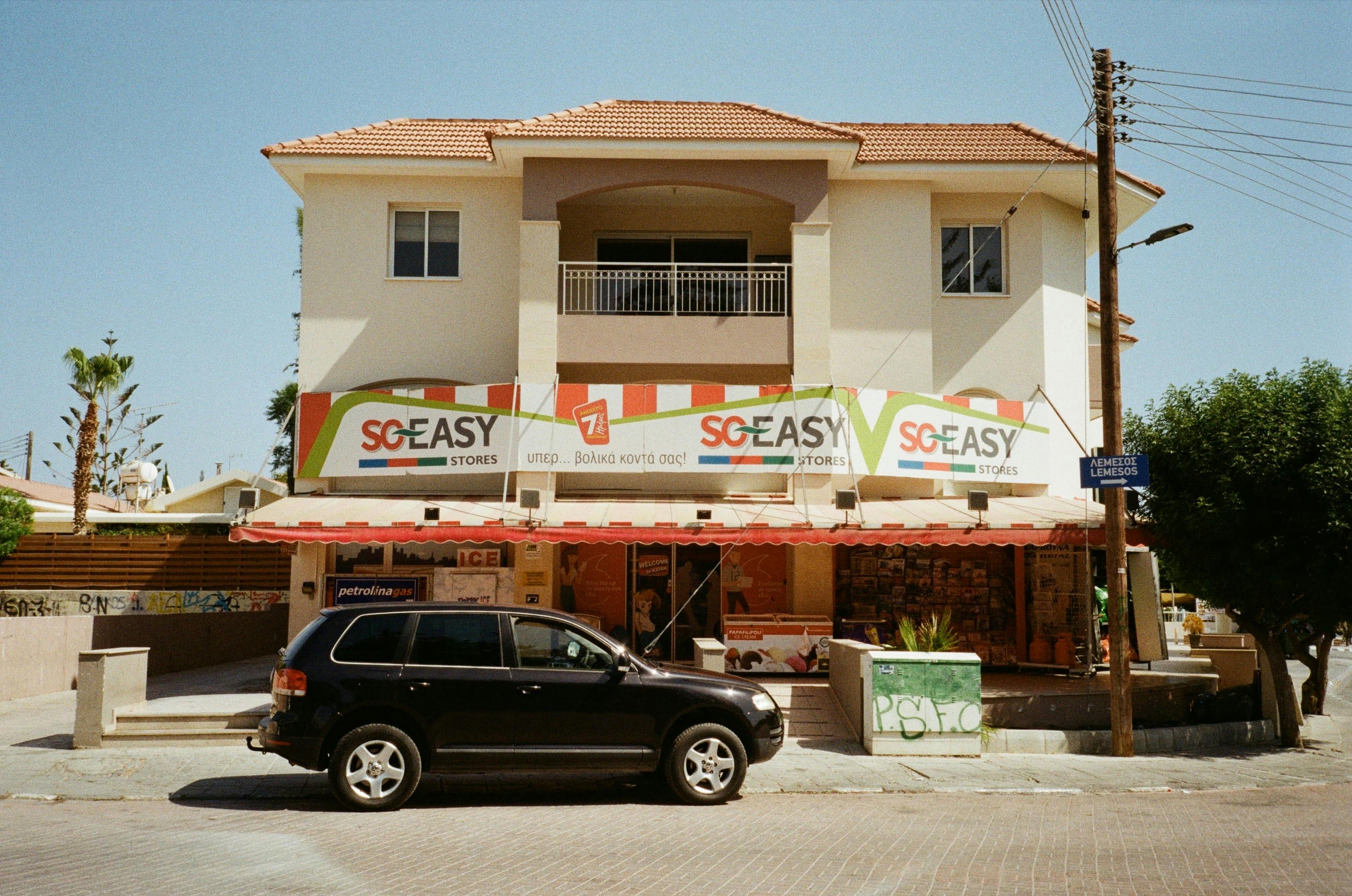 Black Car Parked in Front of a Store